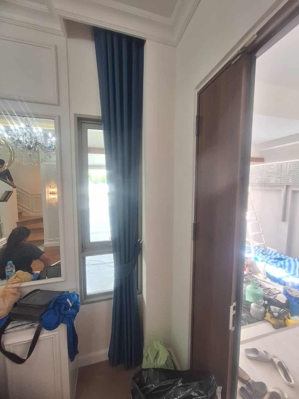 Navy curtain hung high on a stairwell window